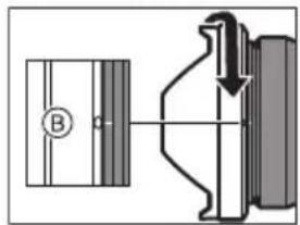 Technical diagram showing a mechanical assembly with labeled component B and directional arrow indicating motion or force