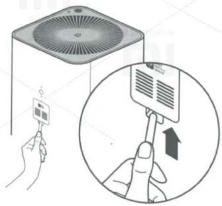 Diagram showing a hand holding a device next to an air conditioner unit, with an inset magnified view highlighting the device's adjustment.