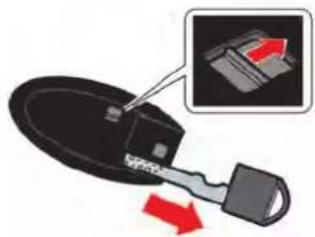 Close-up of a black mechanical component with a red arrow indicating direction, showing internal structure and a magnified inset (no text or symbols)