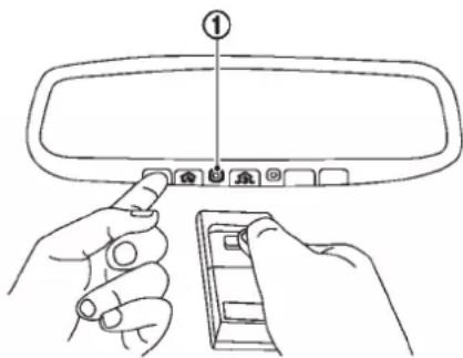 Diagram showing hand positioning a rear mirror with labeled component (①) and device panel