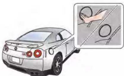 Illustration of a car with a magnified inset showing hand holding a circular object (no text or symbols)