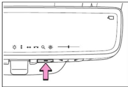 Diagram of a door handle with directional arrows and a pink arrow pointing to a component, indicating movement or force.