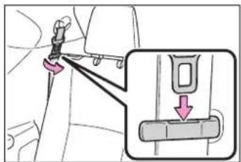 Diagram showing car seatbelt buckle adjustment with magnified detail view