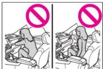 Illustration showing a child seated in a car seat with a 'no' symbol above, indicating no smoking or no smoking.