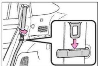 Diagram showing car seatbelt buckle adjustment with magnified detail view