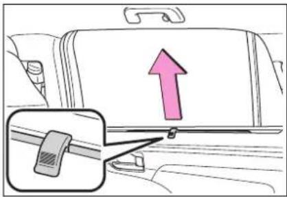 Diagram showing car seatbelt buckle with upward arrow and belt buckle inset