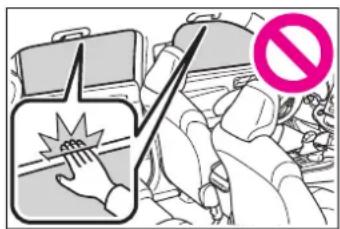 Safety warning illustration showing a hand pressing a shock wave on a train, with a pink prohibition symbol nearby.
