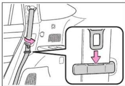 Diagram showing car seatbelt buckle adjustment with magnified detail view