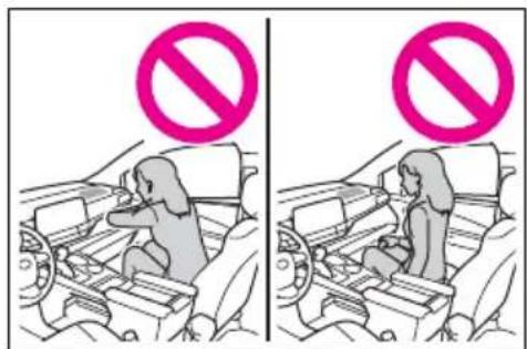 Diagram showing two scenarios of a car with a 'no' symbol, one in a seat and the other in a seat, both marked with pink prohibition signs.