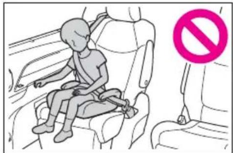 Illustration showing a child sitting on a car seat with a 'no' symbol indicating no restriction.