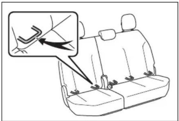 Diagram showing car seatbelt buckle adjustment with magnified detail view highlighting the switch mechanism
