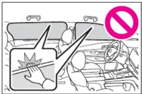 Safety warning illustration showing a hand holding a fuse with a 'no' symbol, next to a vehicle interior with driver and steering wheel.