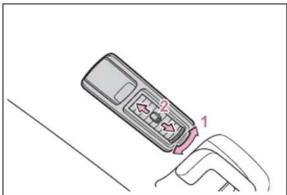 Diagram showing a remote control device with labeled parts 1 and 2, indicating directional movement or status.