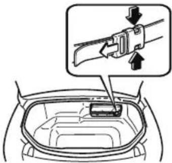Diagram showing a car interior with a belt buckle being inserted, labeled with arrows indicating force direction.