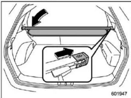 Diagram showing car interior with a hand holding a device and directional arrows indicating movement or change.