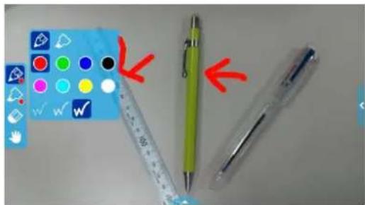 Image showing a blue calculator with colored buttons and three pens, some marked with red arrows indicating selection or comparison.