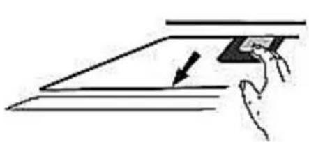 Simple line drawing of a hand holding a tablet over a flat surface, with an arrow indicating direction (no text or symbols)