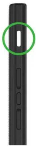 Close-up of a black cylindrical object with a green circular highlight and a white rectangular cutout (no text or symbols)