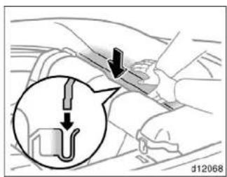 Diagram showing a mechanical component with arrows indicating direction, including a magnified inset of a U-shaped component.