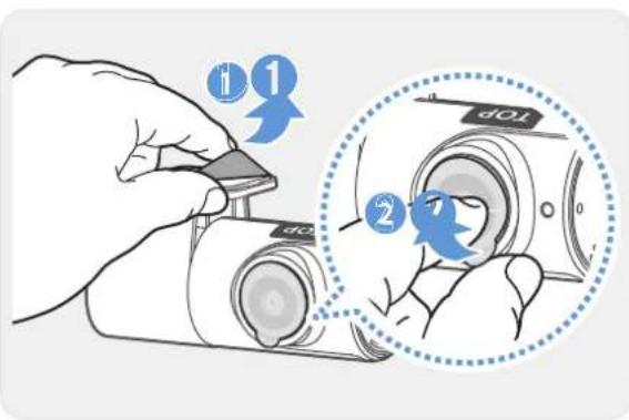 Diagram showing a hand inserting a component into a camera lens, with numbered instructions and a magnified view highlighting the top view.