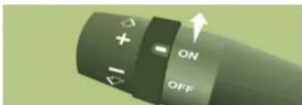 Close-up of a handheld device control knob with ON/OFF buttons and directional arrows