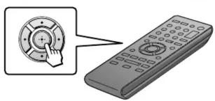 Diagram showing a hand pressing a circular button on a remote control with a keypad and display screen