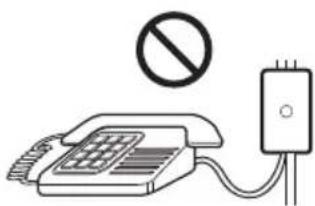 Diagram showing a telephone with a prohibition symbol above it and a connected device with a plug, indicating no protection or disapproval.