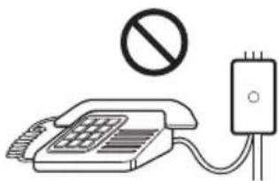 Diagram showing a telephone with a prohibition symbol above it and a connected device with a plug, indicating no restrictions or prohibition.