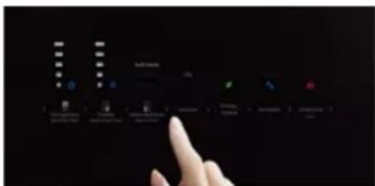 Hand interacting with a touchscreen display showing icons and text labels