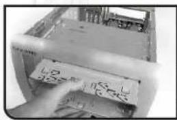 Close-up of a printer's front panel with visible printed labels and a hand pointing to it