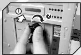 Photo of a computer interface showing a hand pressing a button labeled with numbered components and an arrow indicating rotation.