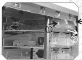 Black-and-white photo of a mechanical or electrical cabinet with numbered annotations pointing to components.