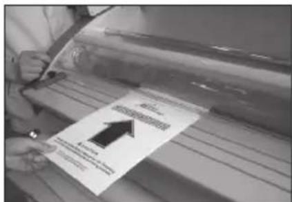 Person reviewing a printed document with an upward arrow, likely indicating a notice or instruction.