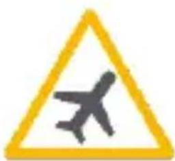Yellow triangular warning sign with airplane symbol indicating travel or aviation risk