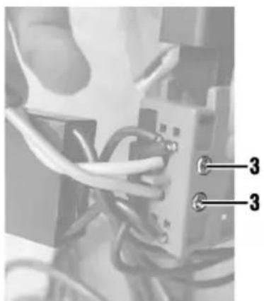 Close-up of hands connecting wires to a small electronic component (no visible text or symbols)