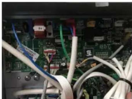 Close-up of an electronic circuit board with visible wiring and components (no readable text or symbols)