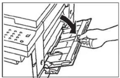 Technical diagram showing a hand inserting a component into a device with labeled parts and arrows indicating direction.