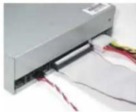 Close-up of a computer drive with visible wiring and a partially open rear panel (no text or symbols)