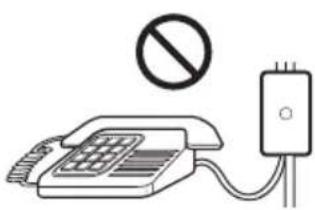 Diagram showing a telephone with a prohibition symbol above it and a connected device with a plug, indicating no restrictions or usage.