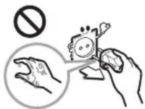 Safety warning illustration showing a hand holding a device with a 'No' symbol and a magnified view of the hand holding a device.