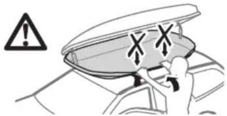 Diagram showing a car interior with warning symbols and a person adjusting the seat, indicating vehicle safety or hazard.