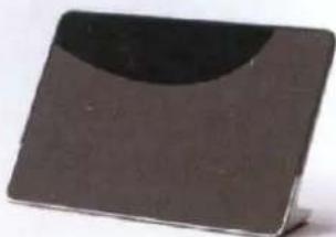 Rectangular metallic object with a curved dark top and small base, no visible text or symbols.