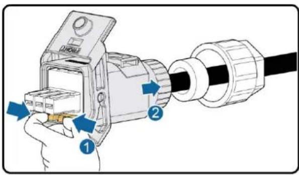 Diagram showing a hand inserting cable into a device labeled with components 1 and 2, indicating assembly or installation steps.