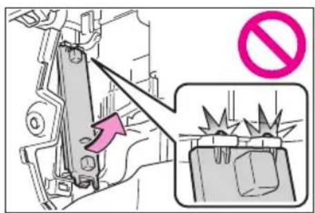 Diagram showing a mechanical device with an arrow pointing to a disassembled structure, accompanied by a no-smoking symbol.