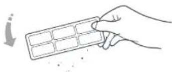 Hand holding a grid-based object with an arrow pointing downward (no text or symbols)