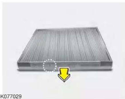 Metallic heat exchanger or filter structure with a yellow arrow pointing to a component (no text or symbols visible)