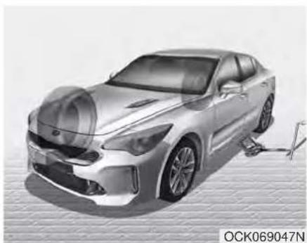 Exterior view of a modern sedan parked under a roof, with a visible suspension line and logo (no text on car or background)