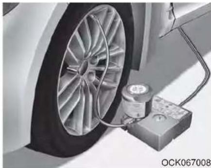 Close-up of a car wheel mounted on a lift with a pressure sensor attached (no visible text or symbols)