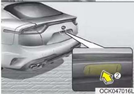 Exterior view of a silver car showing the rear wheel and side panel, with a magnified inset highlighting a component (no text or symbols)