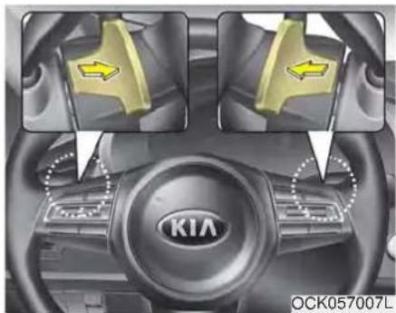 Interior view of a Kia car dashboard with directional arrows indicating movement or change (no text or symbols on the diagram itself)